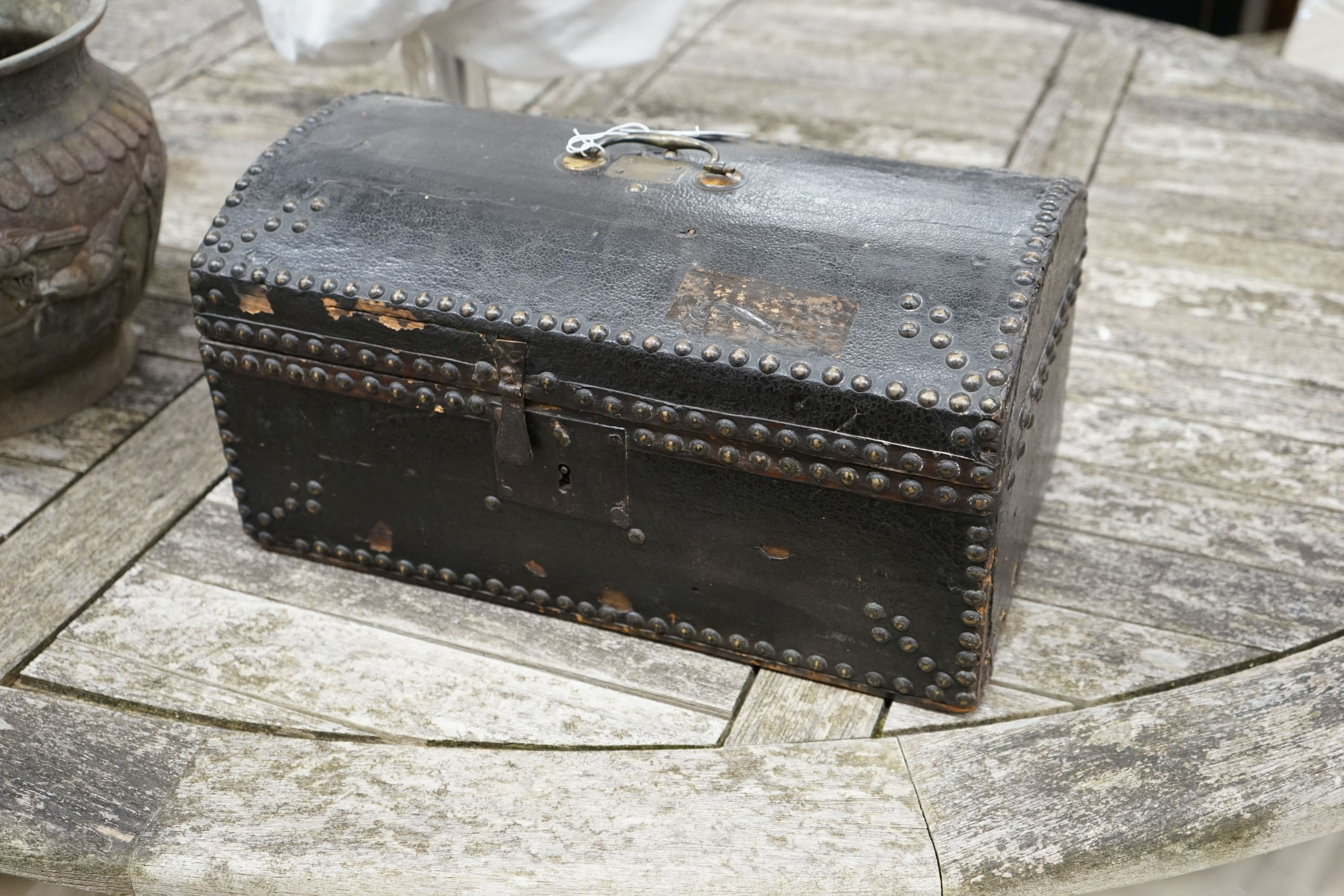 An early 19th century small domed topped leather trunk, bears interior label John Shepherd, Trunk Maker and Undertaker, London, width 45cm, depth 26cm, height 23cm
